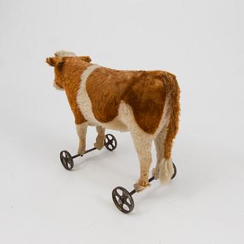A Steiff cow and a Schuco "Tricky", Germany, 1910 and 1930/40s.