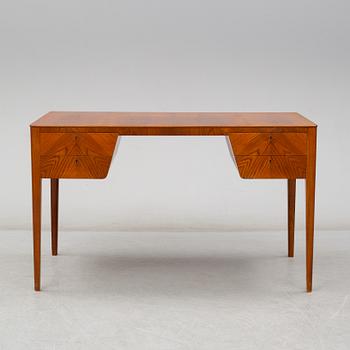 A mid 20th century elm veneered desk.