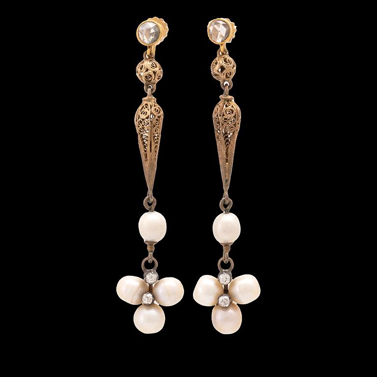 A pair of low-carat gold earrings set with rose-cut diamonds and freshwater pearls from the 19th century.