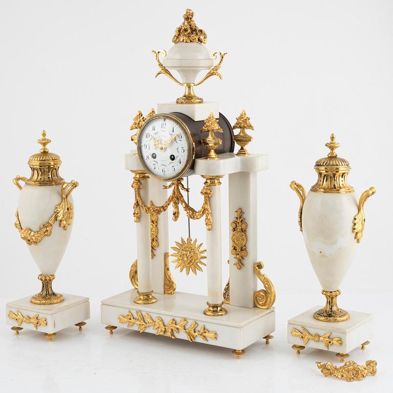 A set with a mantle clock and two urns, France, circa 1900.