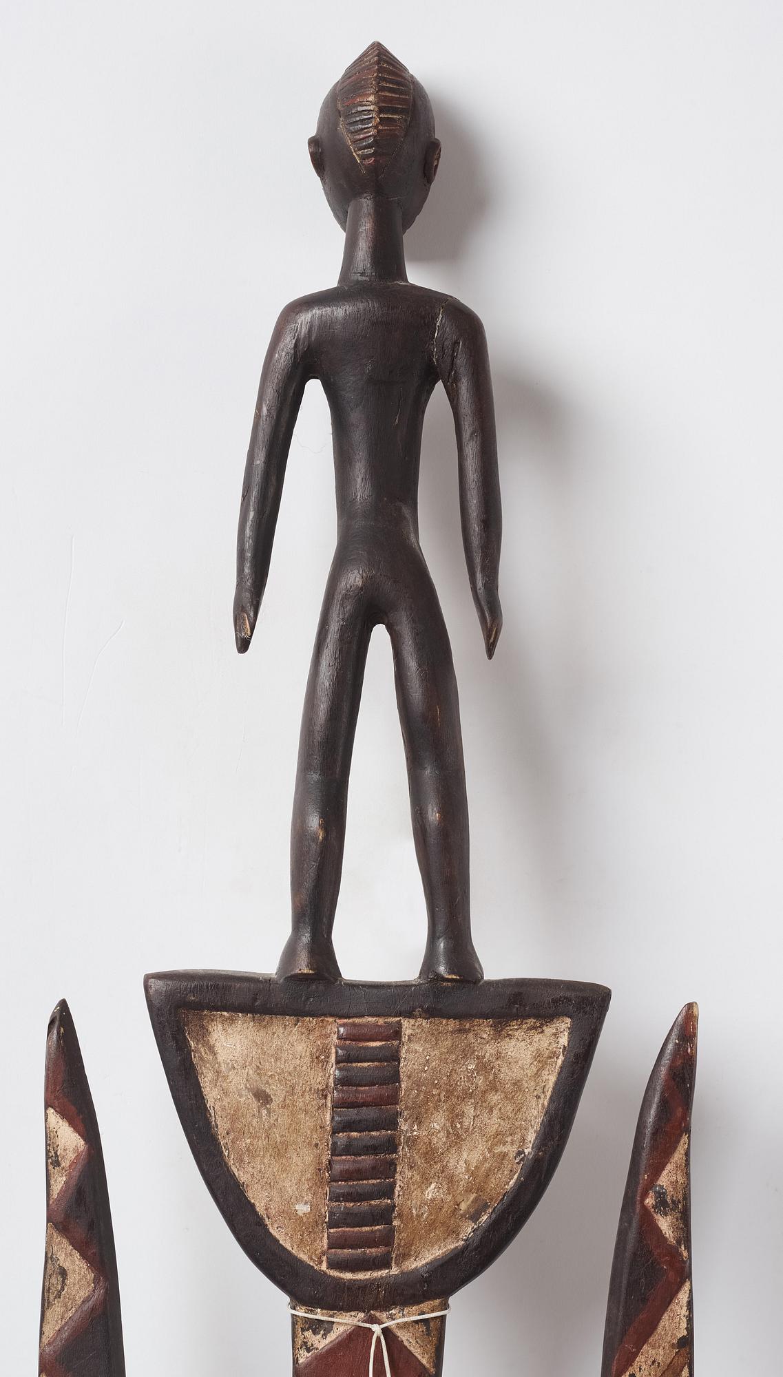 A sculptue and two masks reportedly from The Ivory coast, from the second half of the 20:th century.