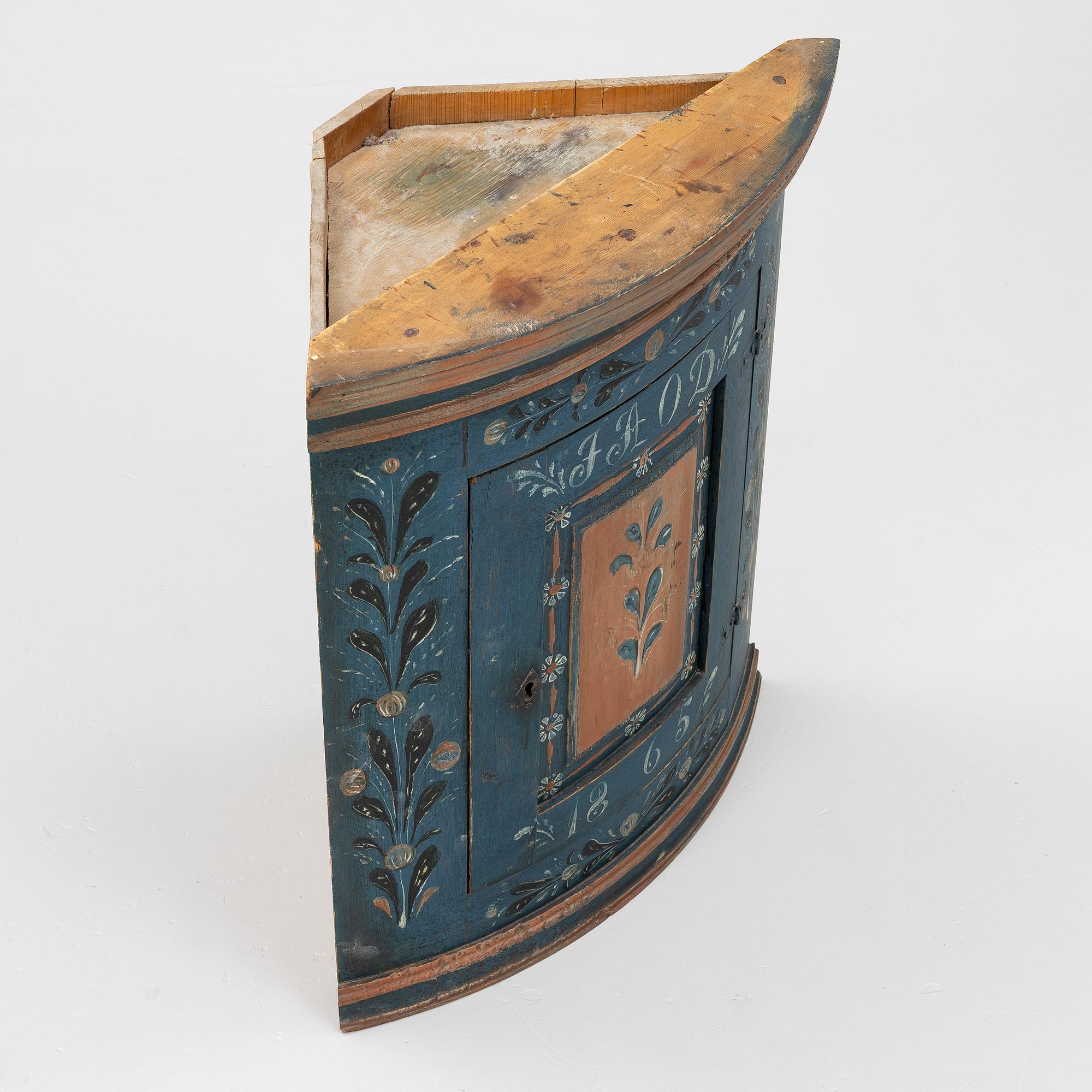 A folk art corner cabinet from Delsbo, Hälsingland, dated 1865.