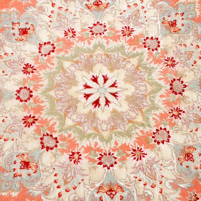 A Täbriz rug, signed, part silk, 210 x 148 cm.