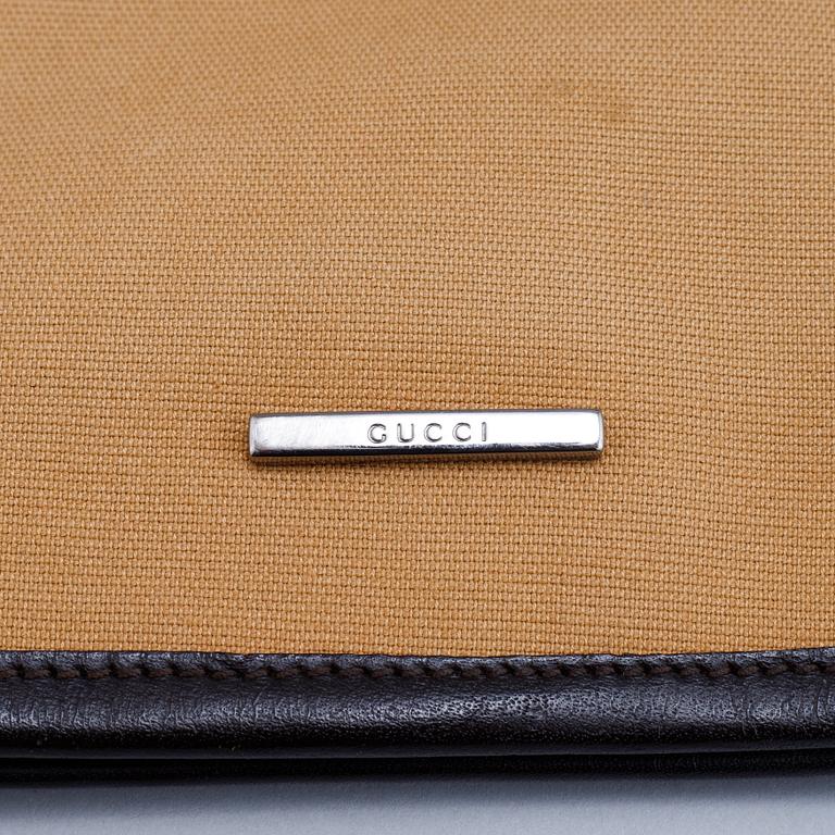 Gucci, a canvas handbag.