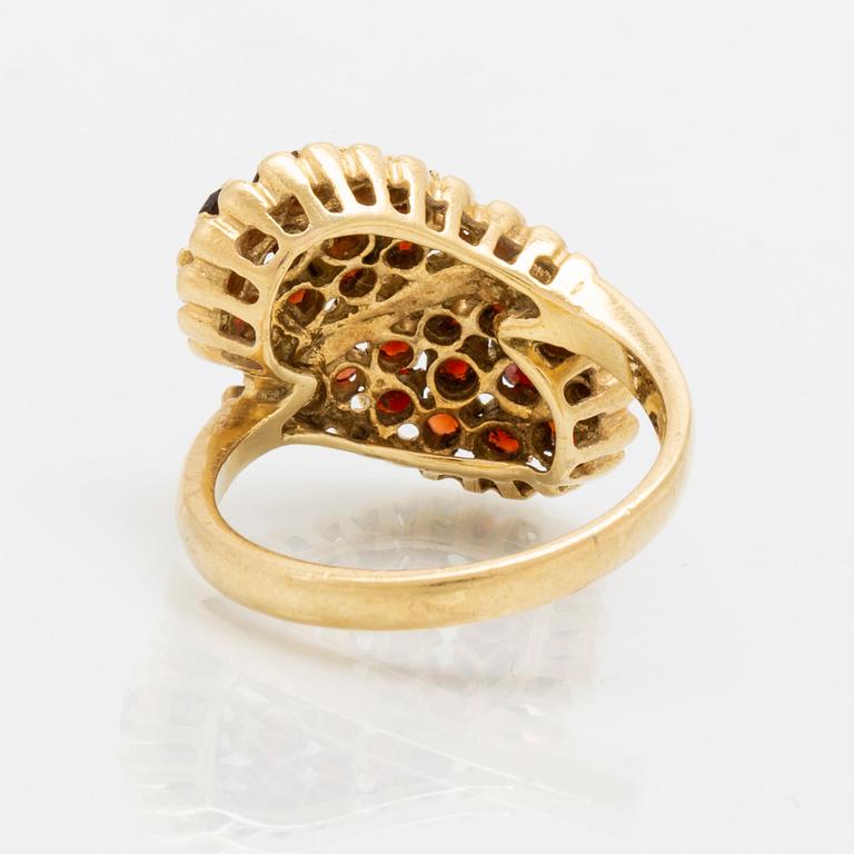 An 18K gold ring with garnets.