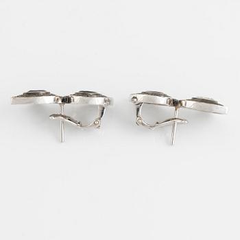 Crow's nest jewels, earrings, white gold with pear shaped diamond and black stone earrings.