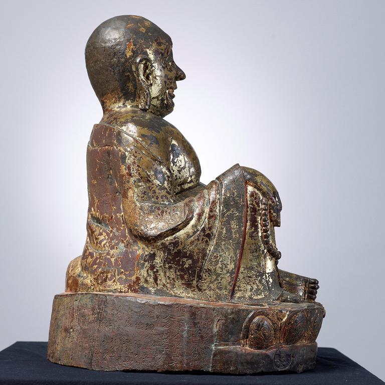 A large seated bronze figure of Budai, Ming Dynasty, dated to the fifth year of Jiajing (1526).