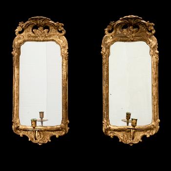 A pair of Swedish Rococo one-light girandole mirrors.