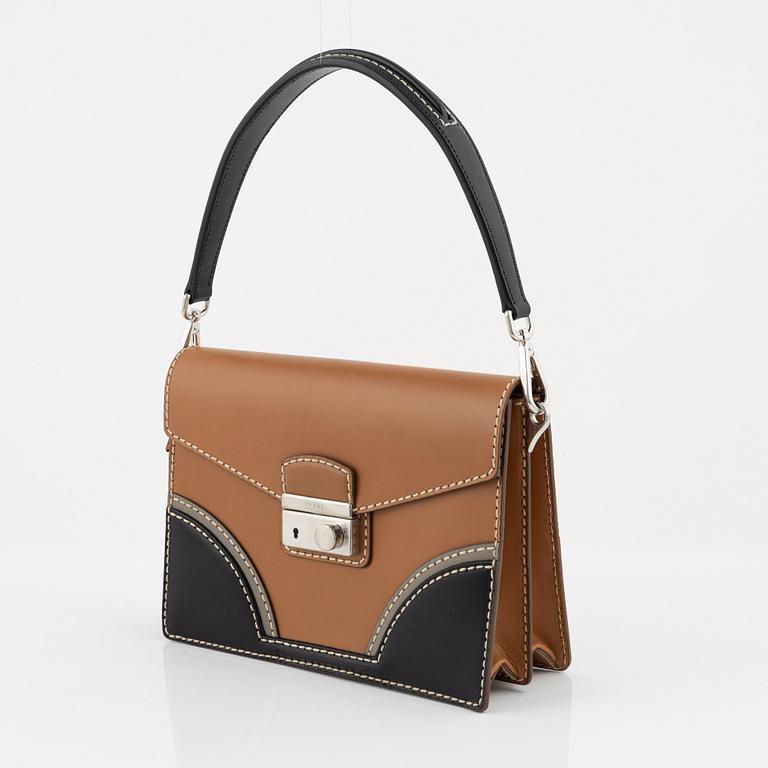 Prada, a leather bag.