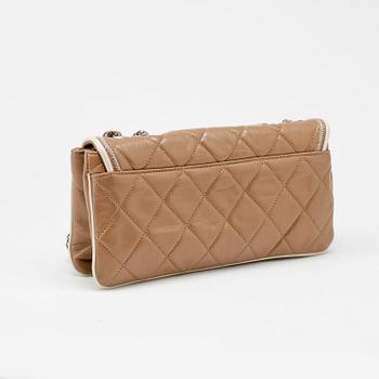 CHANEL, a beige quilted leather flapbag.