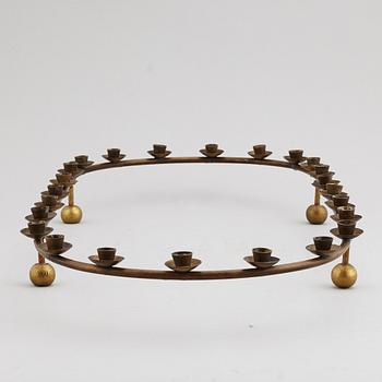A mid 20th Century brass candle ring.