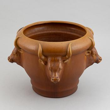 An earthenware pot decorated with four bulls heads. Probably by Karl Hansen Reistrup for Herman Kähler. Around 1900.