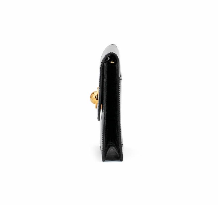 CÉLINE, a black patent leather bag.
