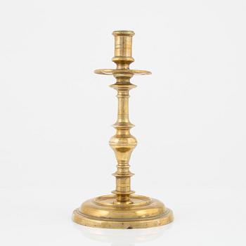 A brass candlestick, 18th century.