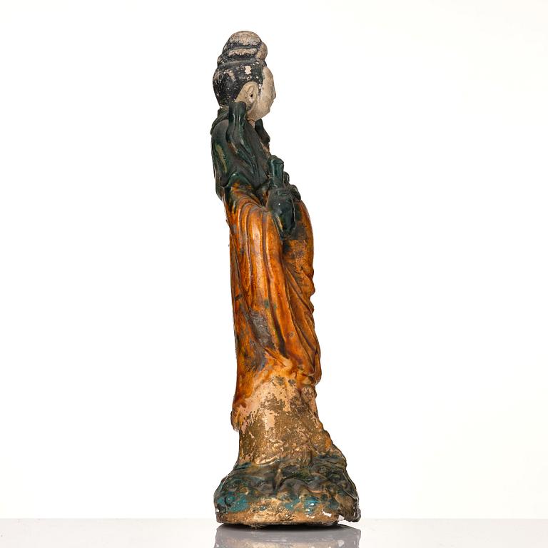 A green and yellow glazed Guanyin figure, late Ming dynasty/Qingdynasty.