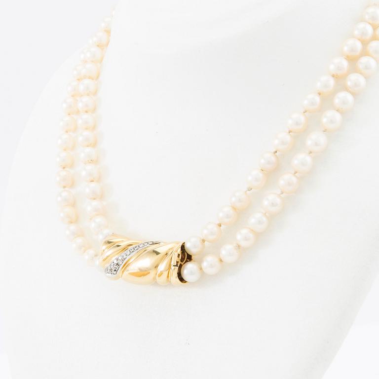 Necklace, two-stranded of cultured pearls with a clasp of 18K gold set with brilliant-cut diamonds, Damini Asolo Italy.