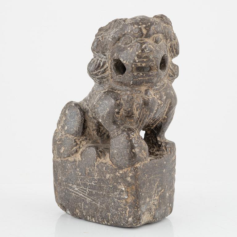 A stone scroll weight/sculpture of a buddhist lion, China, presumably Qing dynasty (1664-1912).