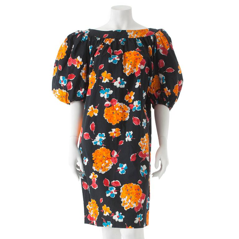 YVES SAINT LAURENT, a black cotton dress with flower motif.
