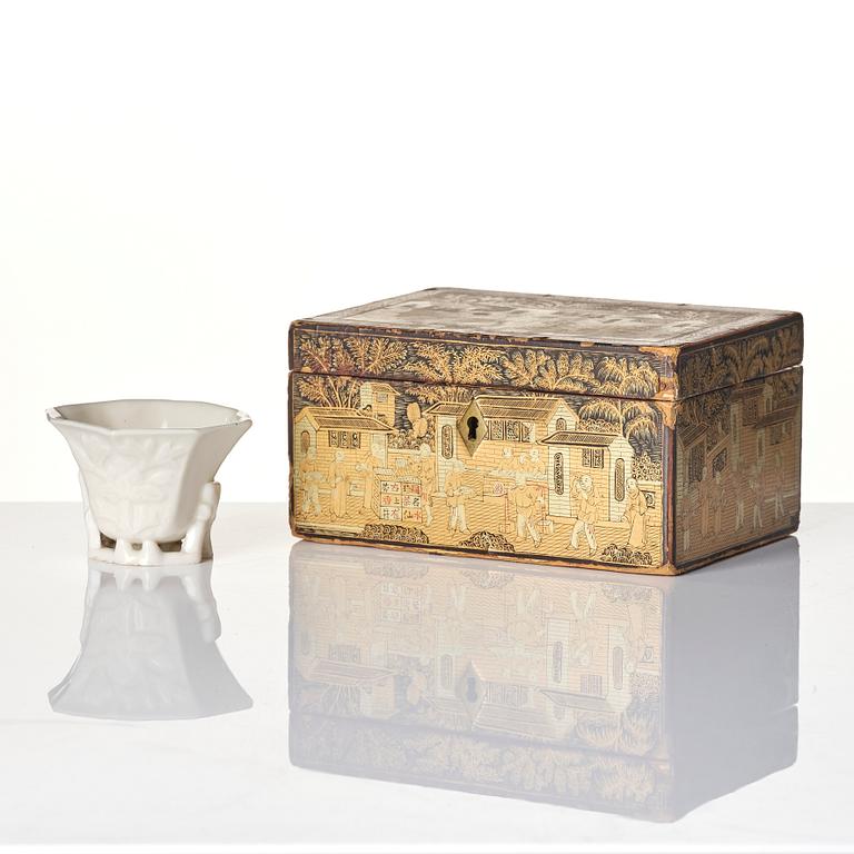 A lacquer tea box and a blanc de chine cup, Qing dynasty 18/19th century.