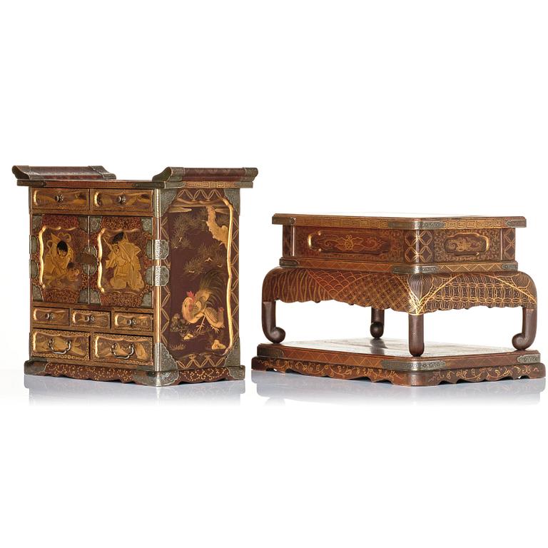 A Japanese lacquer cabinet on a stand, Meiji period (1868-1912).