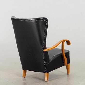 A 1940's - 50's easy chair in black leather, Scandinavian.