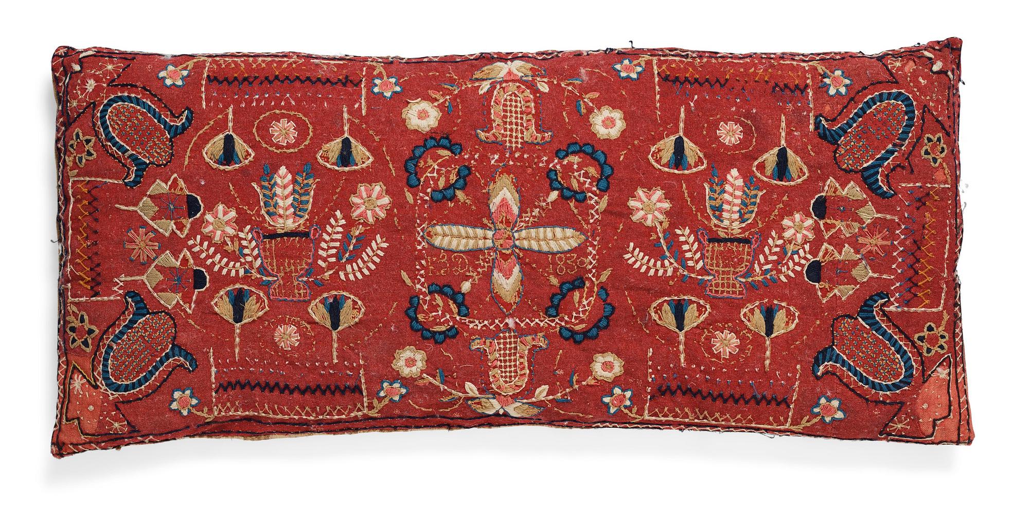 A CARRIAGE CUSHION, "Urnor och blommor", embroidered, ca 48 x 107 cm, Scania, Sweden 1830.
Filled.
