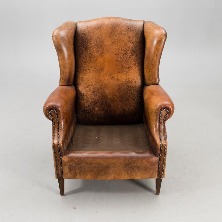 A Chesterfield style armchair from the latter part of the 20th century.