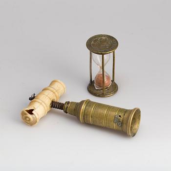 A brass cork screw and hourglass 19th century.