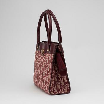 CHRISTIAN DIOR, a red monogram canvas handbag.