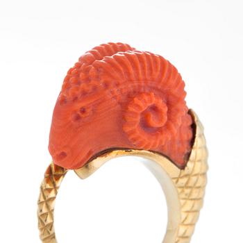 A ring in carved coral in the form of a ram's head.