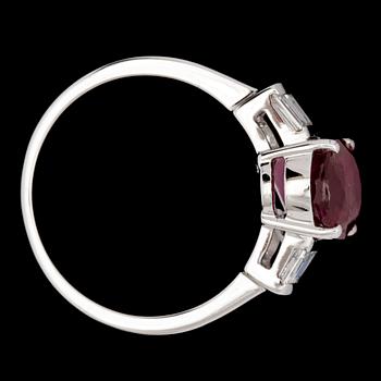 An oval ruby, 3.02 cts, and emerald cut diamond ring.