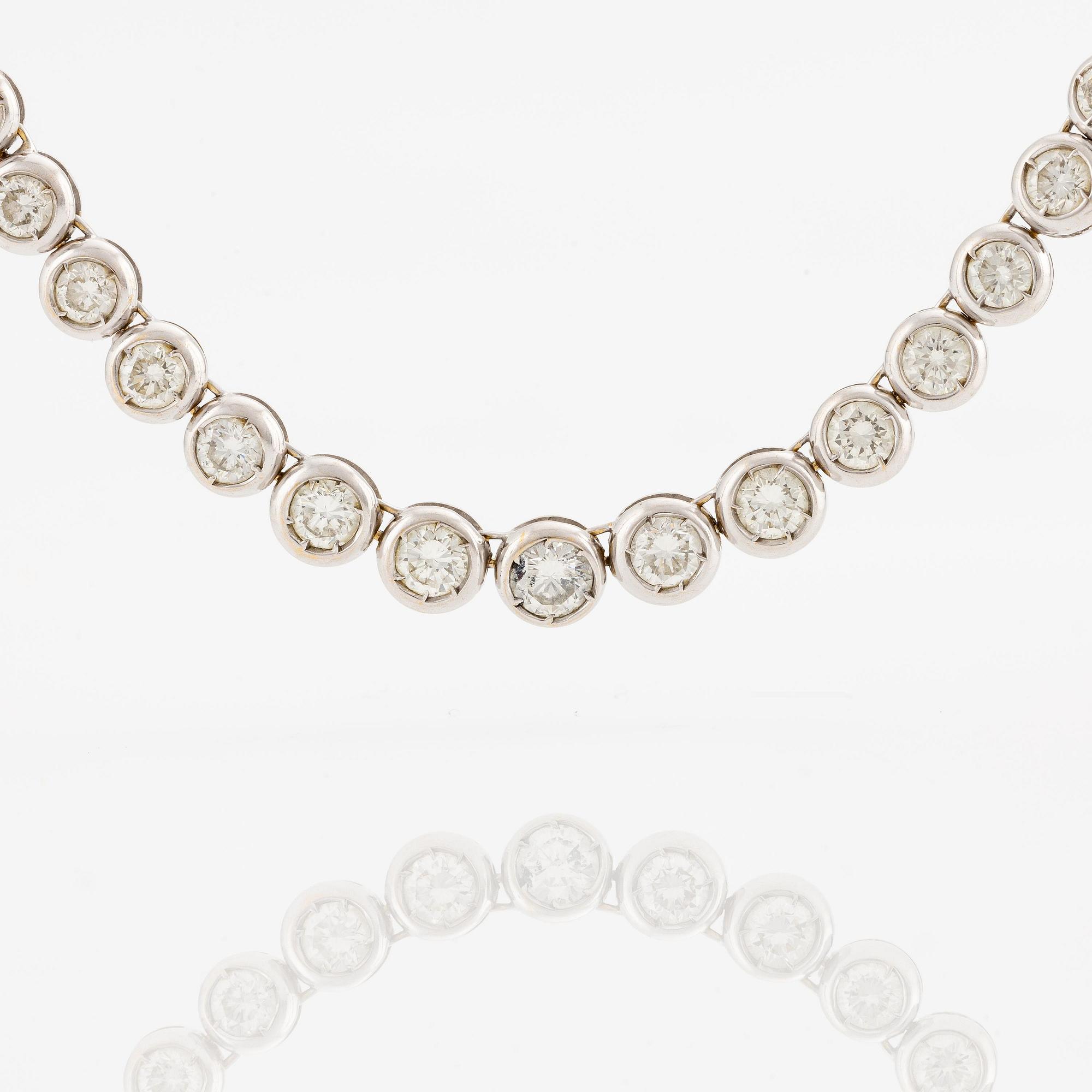 An 18K white gold bracelet set with round brilliant-cut diamonds.