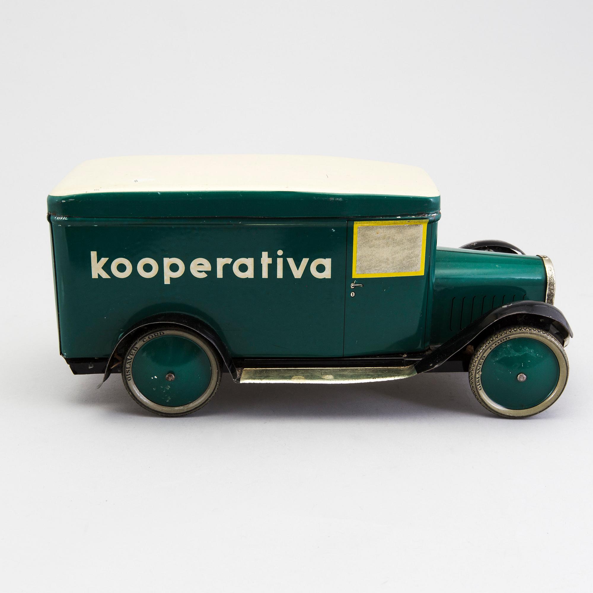 A tinplate biscuit jar in the shape of a truck 1930s.