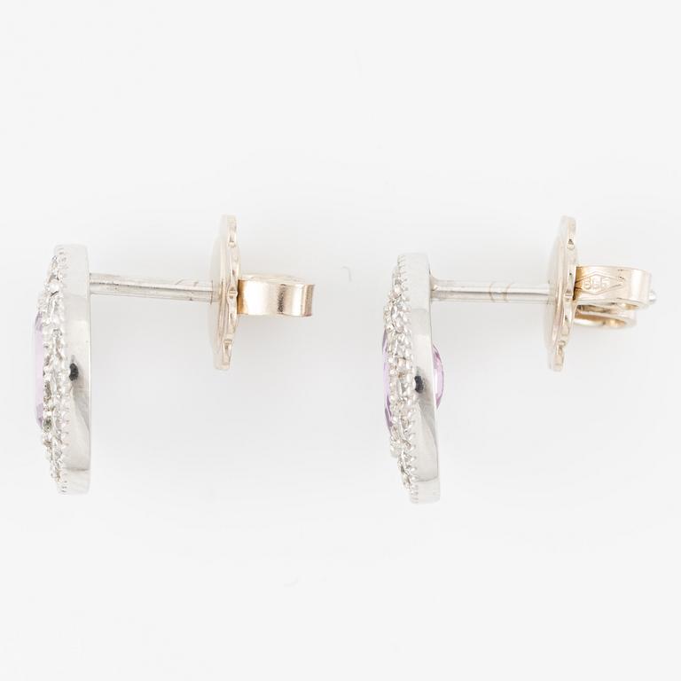 A pair of 14K gold earrings with pink faceted sapphires and round brilliant-cut diamonds.