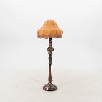 An early 1900s oak floor lamp.