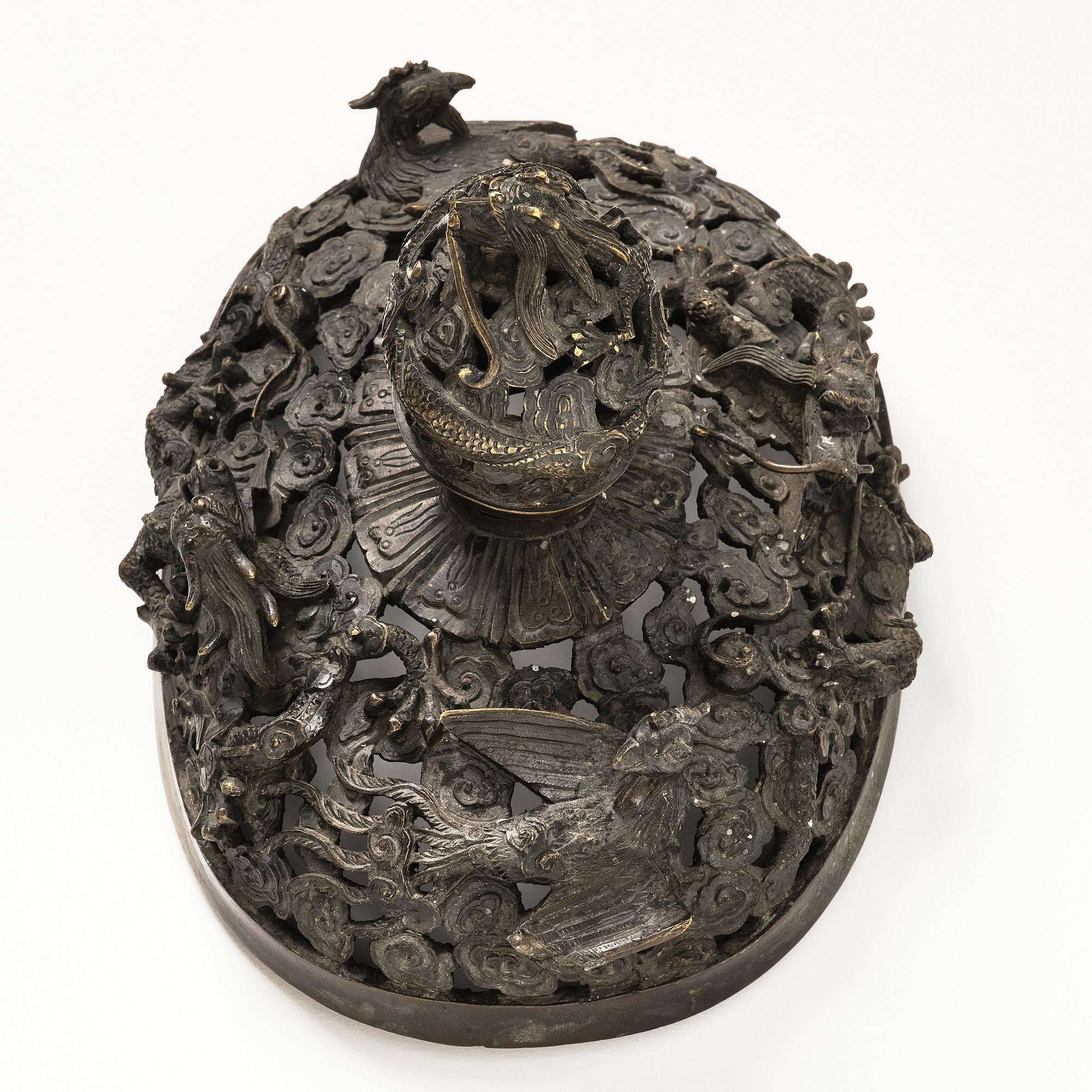 A bronze reticulated incense burner with cover, Qing dynasty (1644-1912).