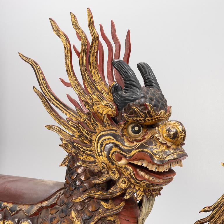 A pair of large Qilin sculptures, lacquered wood, first part of the 20th century.