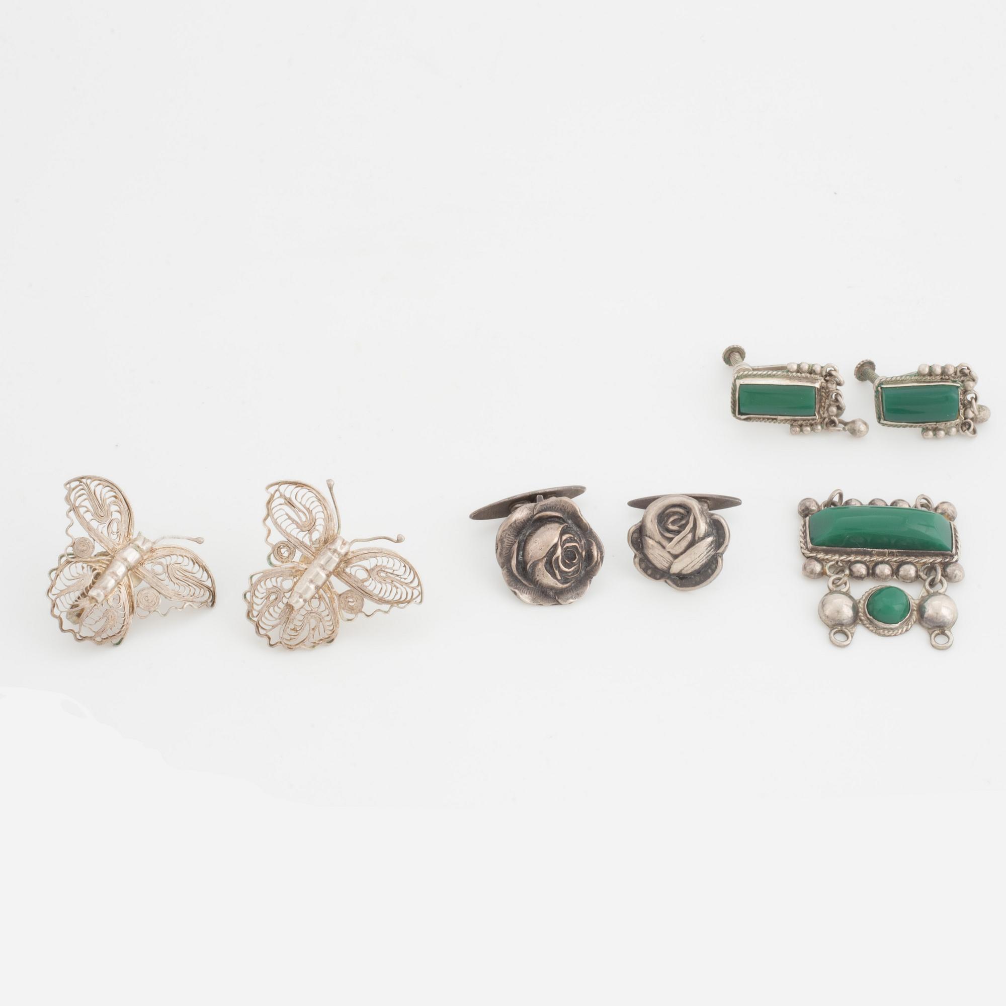A silver belt buckle, three bracelets, two pairs of earrings, a pair of cuff-links and a brooch.