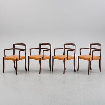 A set of four black stained beech tree arm chairs with leather upholstery, second half of the 20th century.
