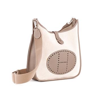 407. HERMÈS, a canvas and grey leather crossbody bag, "Evelyn".