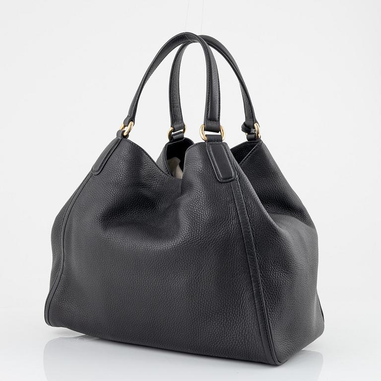 Gucci, a black leather handbag.