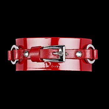 1442. A red lacquer bracelet and a pair on earclips by Christian Dior.