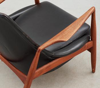 An Ib Kofod Larsen black leather and teak easy chair 'The Seal' by OPE, Sweden 1950-60's.