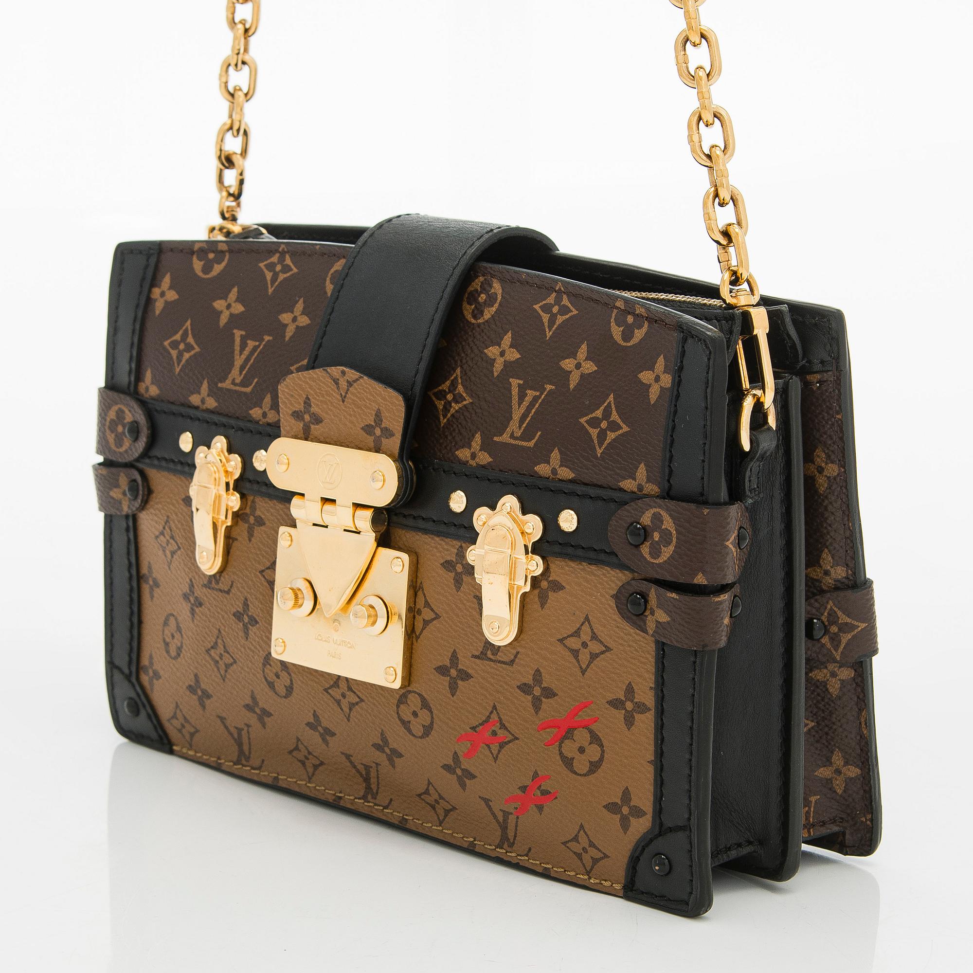 Louis Vuitton, a "Reverse Monogram Trunk Clutch" bag.
