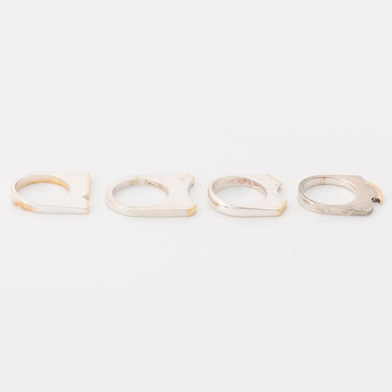 Rolf Karlsson four silver rings with gold details.