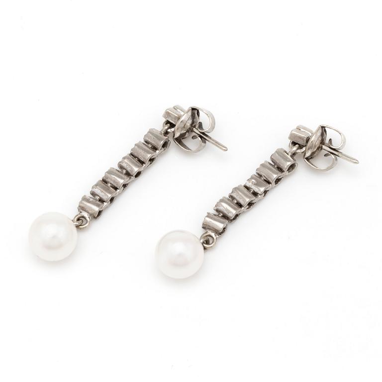 A pair of earrings with cultured pearls and eight-cut diamonds.