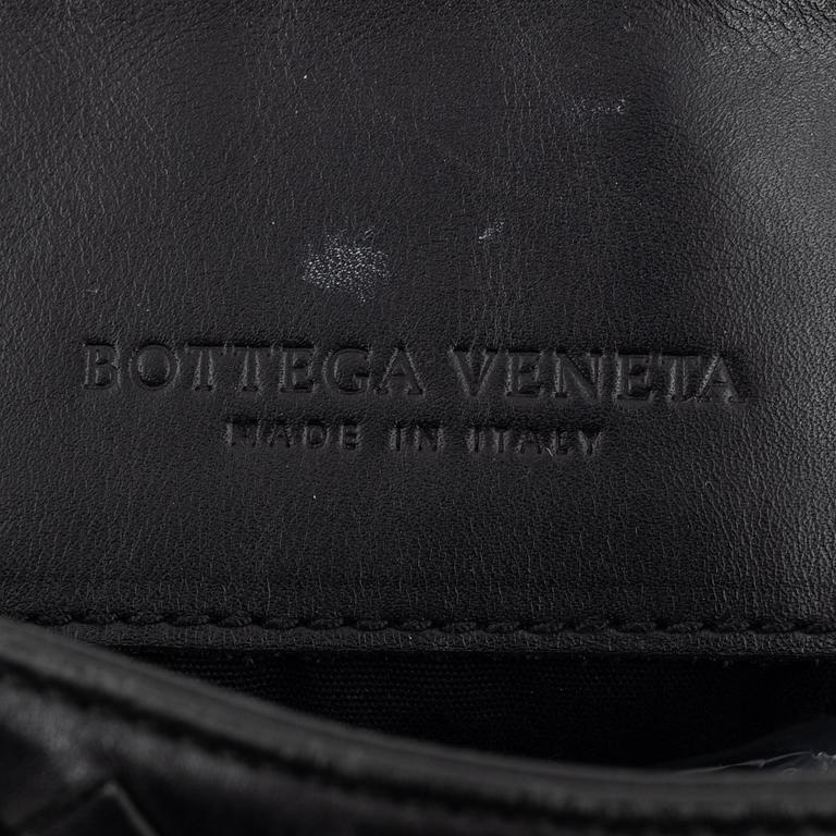 Bottega Veneta, a black intrecciato leather bag.