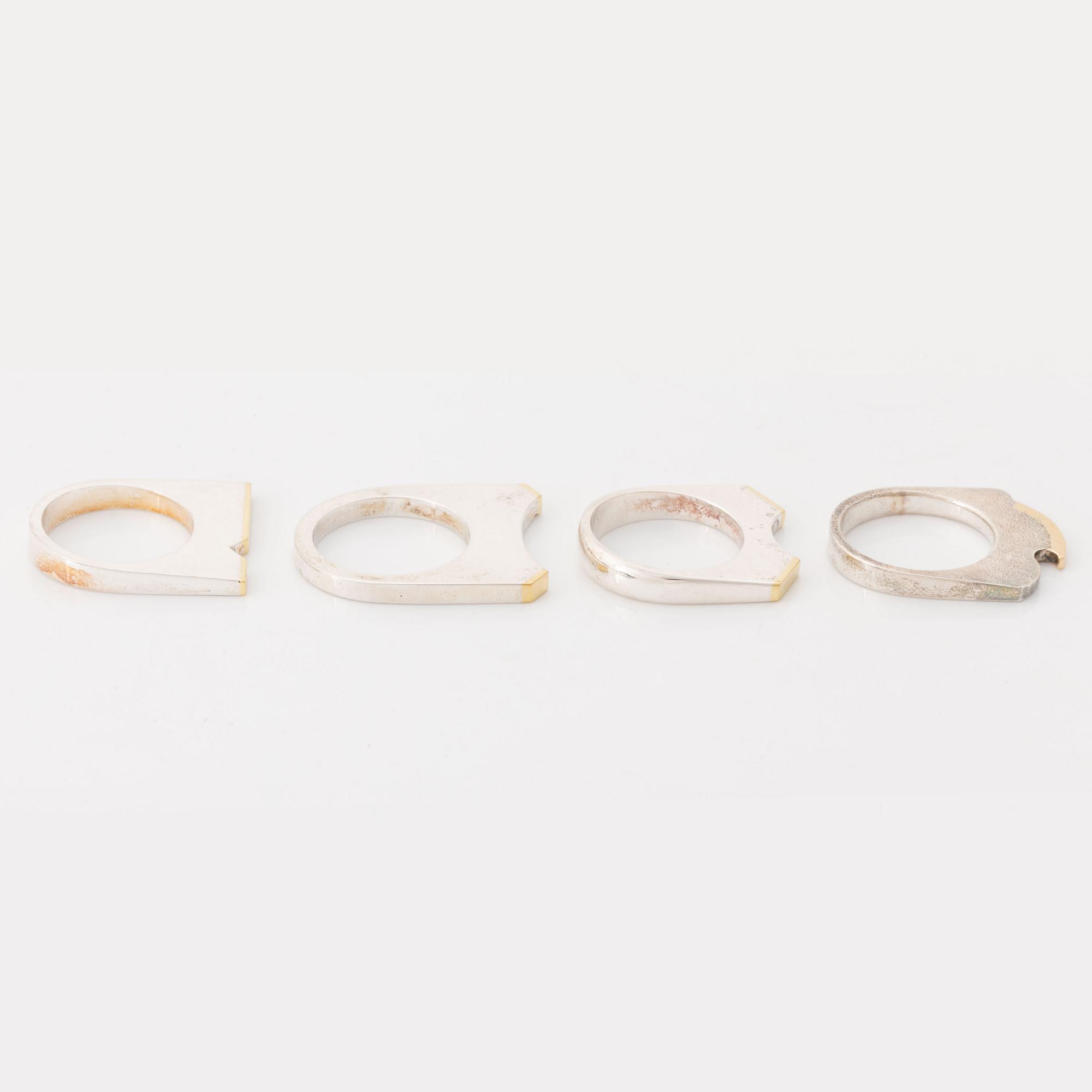 Rolf Karlsson four silver rings with gold details.