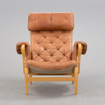 A Bruno Mathsson 'Pernilla' beech, canvas and brown leather easy chair, DUX, Sweden.