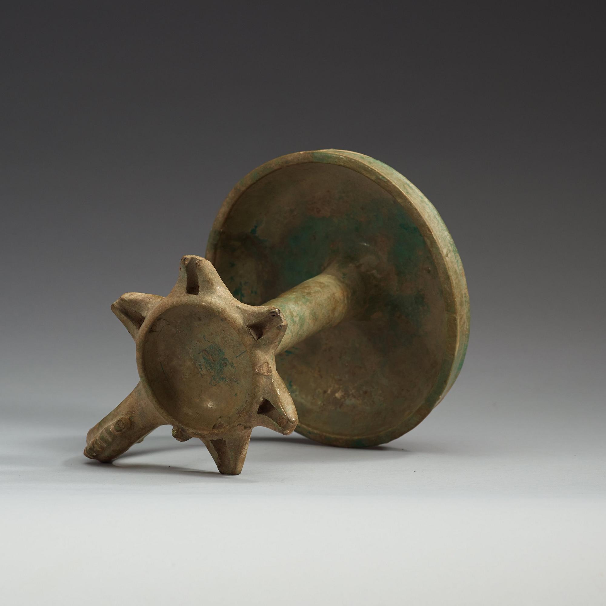 AN OIL LAMP, pottery with turquoise glaze. Height 21,5  cm. Persia (Iran), possibly Kashan 13th century.